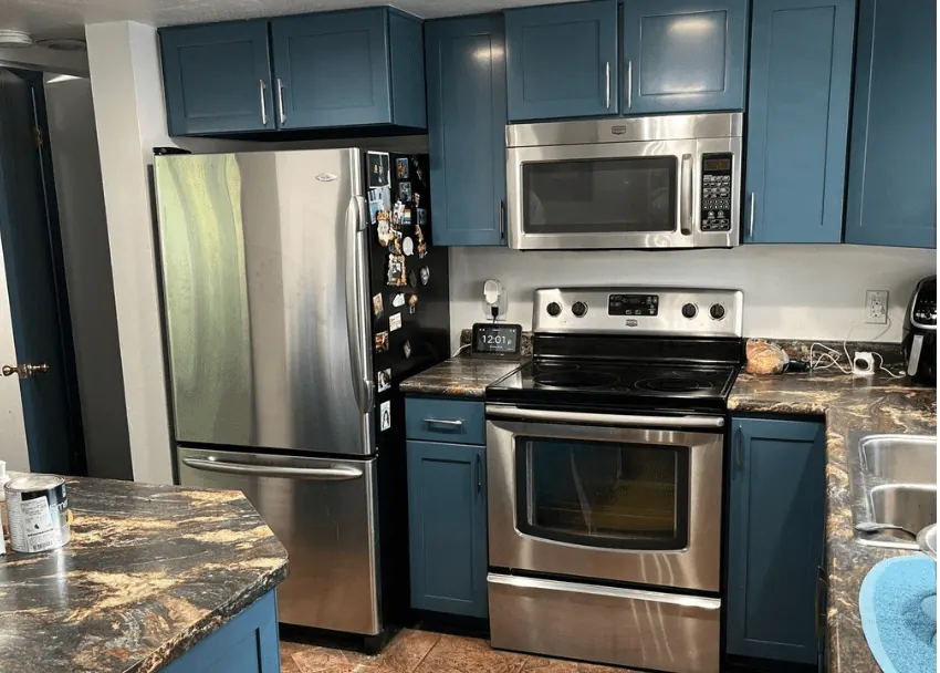 Kitchen cabinets painted in a deep navy Dark Night shade